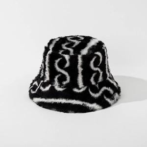Detail of plush bucket hat featuring soft faux fur texture and black white wavy patterns