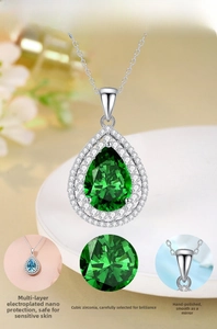Detail view of pear-cut emerald cubic zirconia pendant in polished S925 silver halo setting