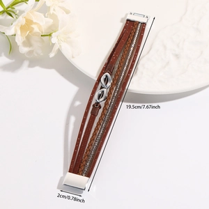 Detail of bohemian multilayer brown leather bracelet with infinity charms and magnetic clasp