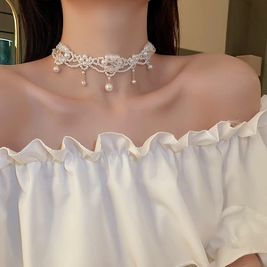 Detailed view of elegant faux pearl flower choker with crystals on model neck