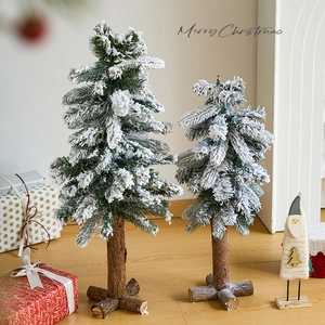 Miniature flocked Christmas trees with natural wood base for festive desktop decoration