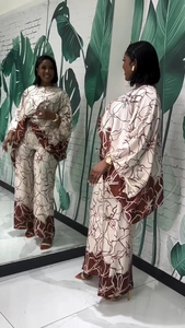 Detail of floral print on loose two-piece set featuring round neck top and wide-leg pants