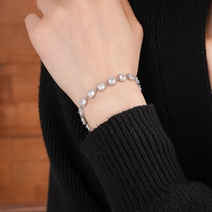 Macro shot of silver heart bracelet with clear cubic zirconia on a wrist detail