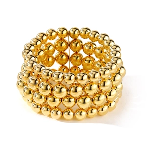 Macro shot of punk style multi-layer gold bead chain bracelet set with metallic luster