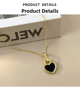 Detail view of a S925 silver gold heart pendant with black inlay on a fine bead chain