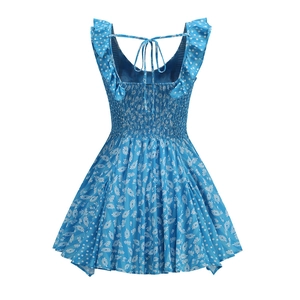 Detail view of the smocked back design and floral tie-up straps on a blue summer dress