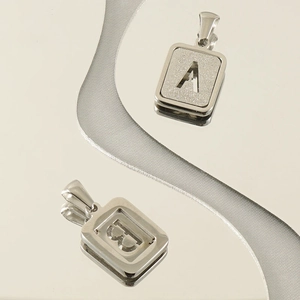 Polished stainless steel letter A and B pendants with sandblasted interior finish