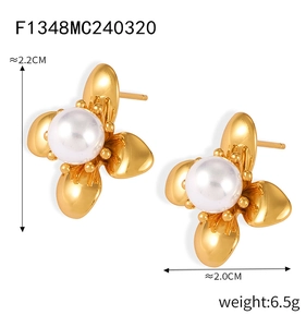 Detailed view of flower-shaped gold earrings with pearls and size measurements