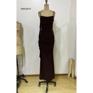 Detail of dark chocolate slip dress featuring ruched side seams and ruffled hemline