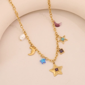Close-up of gold moon and star necklace with blue purple gems and white pearls