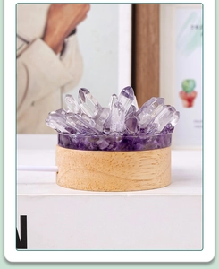 Detailed macro view of amethyst crystal cluster lamp on a round wooden base with USB cable