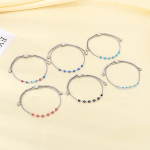 Set of six silver bracelets featuring multi-colored evil eye beads and heart charms