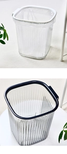 Detail of square transparent trash bin with vertical stripes and blue retention ring