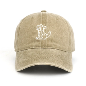 Detailed close-up of embroidered cartoon dog on washed khaki cotton baseball cap