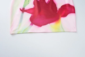 Close-up of the vibrant floral print and smooth fabric texture on this slim fit bodycon dress