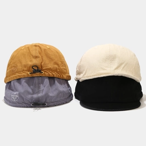 Details of vintage washed canvas dad hats in mustard, gray, cream, and black colors