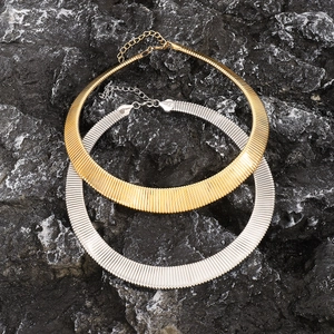 Flat snake bone wide choker necklaces in gold and silver finish on stone background