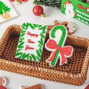 Christmas fondant cookie mold set with Happy New Year cookies in a woven basket
