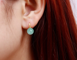 Close-up of S925 silver gold-plated hook earring with round green aventurine bead