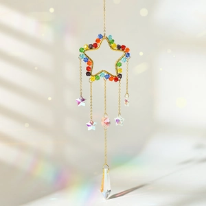 Close-up of golden star crystal suncatcher with colorful beads and rainbow light effects