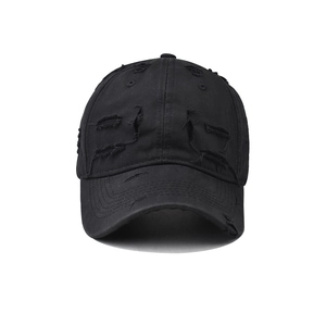 Distressed black cotton baseball cap with ripped holes and vintage streetwear aesthetic