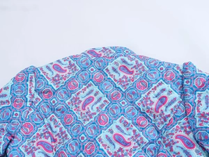 Detail of blue and purple paisley quilted pattern on woman's fashion winter jacket