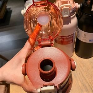 Detail view of brick red vacuum flask lid with direct drinking spout and leakproof seal