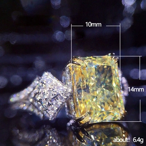 Luxurious 10x14mm radiant cut yellow gemstone ring with silver band and side stones