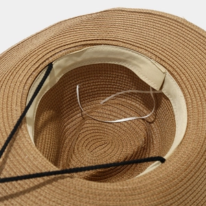 Detail view of the straw hat interior featuring sweatband and adjustable drawstring