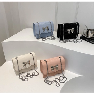 Chic velvet crossbody bag with silver bow accent and chain strap in four soft colors