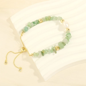 Detail of beaded bracelet with green gravel stones, white pearl and adjustable gold slider