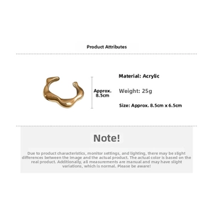 Detail view of wavy golden acrylic ear cuff showing 8.5cm by 6.5cm size and 25g weight