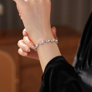 French vintage pearl bracelet with irregular zircons on elegant female wrist
