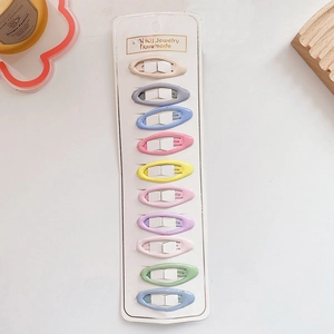 Close-up of ten colorful candy-toned children's BB hair clips arranged on a display card