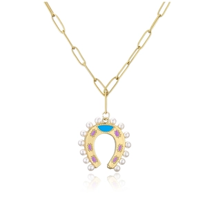 Detailed macro view of a gold horseshoe pendant with pearls and colorful enamel on a paperclip chain