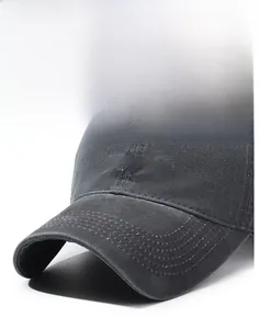 Close-up of white embroidered letters on washed dark grey vintage cotton baseball cap