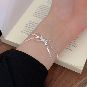 Minimalist S925 sterling silver blade chain bow bracelet worn on a female wrist