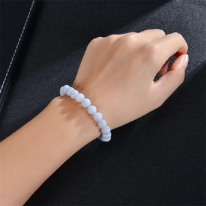 Detailed close-up of light blue apatite beaded stretch bracelet on a female wrist