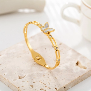 Detail of 18K gold butterfly bangle with shell inlay and shimmering rhinestones