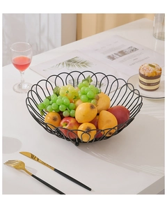 Close-up of a black metal wire fruit basket with elegant petal edges and fresh fruits