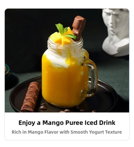 Detail of a portable blender cup with handle filled with mango smoothie and fresh fruit