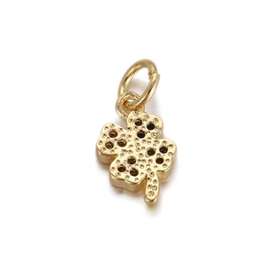 Detail of 18K gold plated four-leaf clover pendant with unique textured metal finish