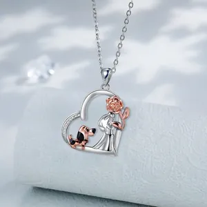 Two-tone heart necklace with rose girl and dachshund dog in sparkling silver and gold