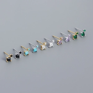 Macro shot of colorful square zircon geometric studs in gold and silver plating