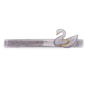 Macro detail of silver-purple glitter hair clip with swan motif and gold outline