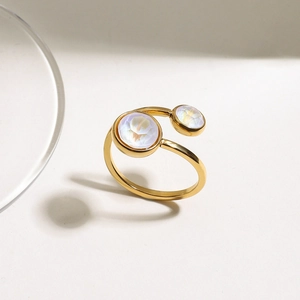Macro detail of 18K gold plated stainless steel open ring with iridescent zircon stone