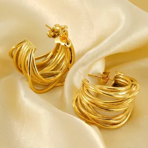 Golden multi-layer geometric C-shaped hoop earrings with polished twisted design
