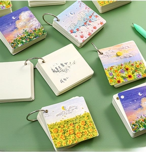 Close-up of portable oil painting landscape flashcards with silver metal binding rings