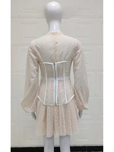 Detail view of the back of a hollow lace corset vest and polka dot puff sleeve dress