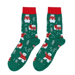 Detail of Christmas cotton socks featuring green knit patterns with polar bears and trees